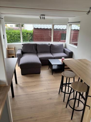 a living room with a couch and a table at Mobilhomme in Brêmes