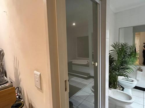 a bathroom with two toilets and a sink at Adorable Pool Side Apartment in Monte Vista