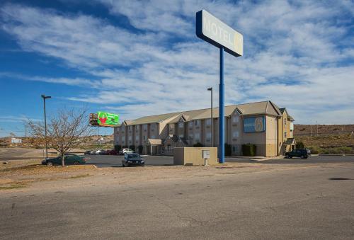 a sign for a hotel on the side of a road at Motel 6-Bernalillo, NM in Bernalillo