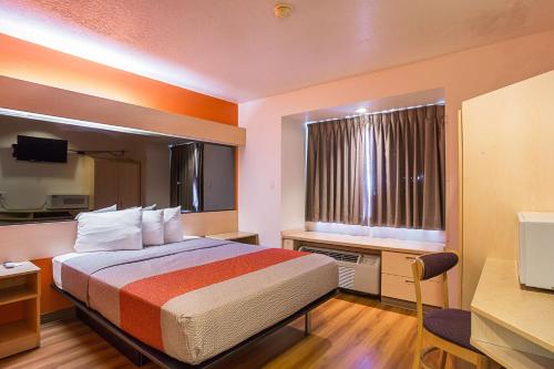 a hotel room with a bed and a window at Motel 6-Bernalillo, NM in Bernalillo