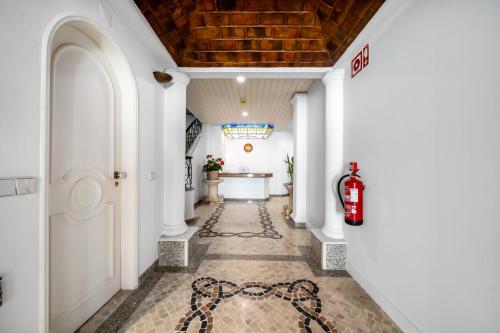 a corridor of a building with white walls at The Royal Guesthouse in Faro