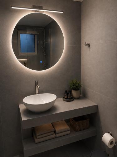 a bathroom with a sink and a mirror at Kleanthi Studios in Chania