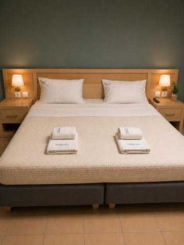 a bedroom with a large bed with two towels on it at Kleanthi Studios in Chania