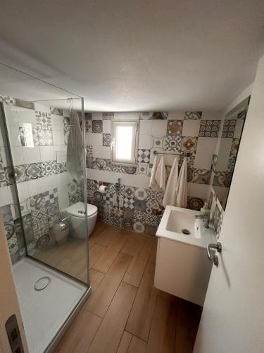 a bathroom with a shower and a toilet and a sink at L'altra opera in Palermo