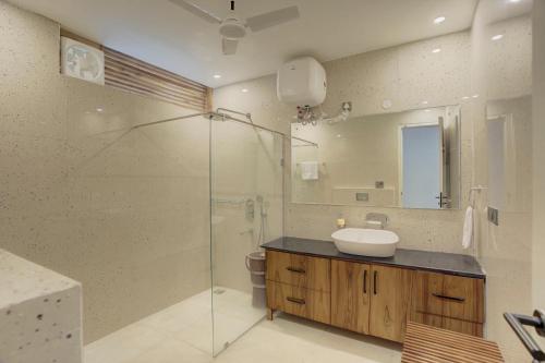 a bathroom with a sink and a glass shower at The Mountain house 4 BHK VIlla With Pool in Rishīkesh