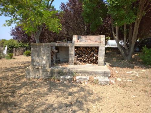 a stone fireplace with a box on top of it at Momon1616 Intero Chalet in Galatina