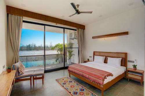 a bedroom with a large bed and a balcony at The Mountain house 4 BHK VIlla With Pool in Rishīkesh