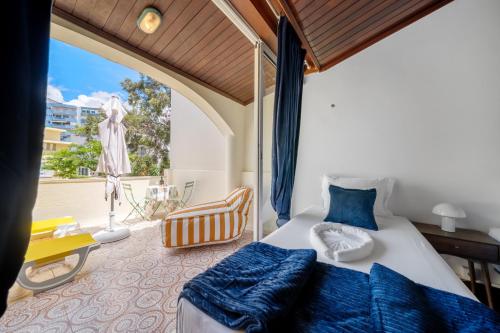 a bedroom with a bed and a large window at The Royal Guesthouse in Faro