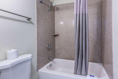 a bathroom with a shower and a toilet and a tub at Motel 6-Mount Vernon, IL in Mount Vernon