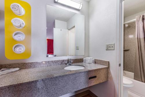 a bathroom with a sink and a mirror and a toilet at Motel 6-Mount Vernon, IL in Mount Vernon