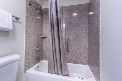 a bathroom with a shower and a toilet and a tub at Motel 6-Mount Vernon, IL in Mount Vernon