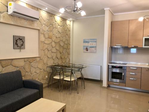 a living room with a table and a kitchen at Thalassa in Siviri