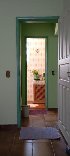 an open door to a room with green walls at hospedagem quarto n3casa da Waldir maria in Goiás