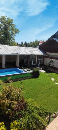 a house with a swimming pool in a yard at GUEST HOUSE "Rohat Lux" in Samarkand
