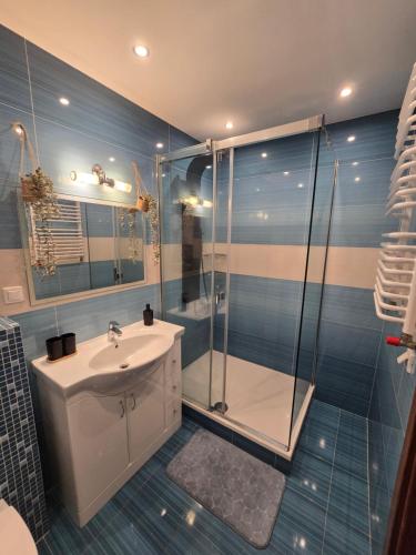 a bathroom with a sink and a shower at Silent Apartment Płock in Płock