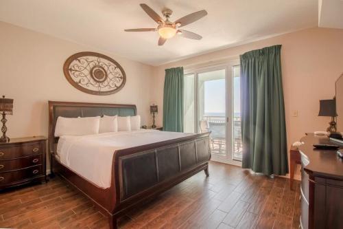 a bedroom with a bed and a ceiling fan at Legacy Tower I in Gulfport