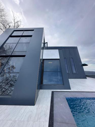 a house with a swimming pool in front of it at Loya Butik Otel Bungalov in Rize