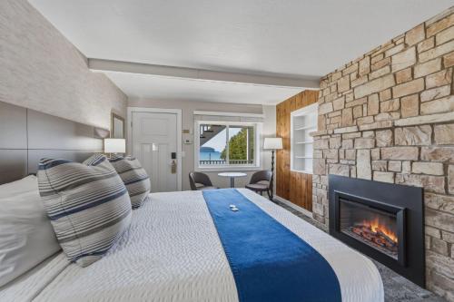 a bedroom with a fireplace and a bed at The Water Street Inn in Ephraim