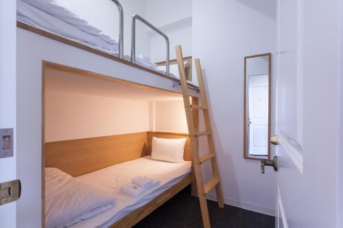 a room with two bunk beds and a ladder at HOTEL THE CUBE Naha Kokusai Street in Naha
