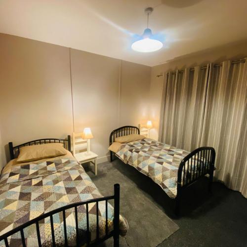 a room with two beds in a room at The Blue Lodge in Galway