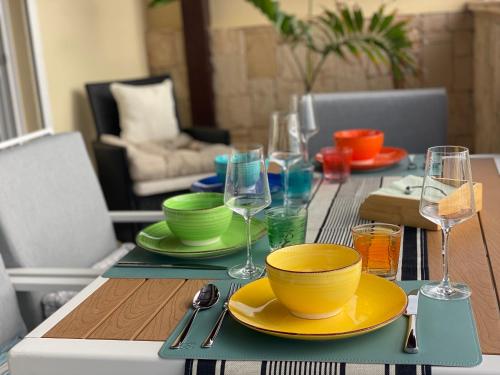 a table with plates and wine glasses on it at Seaview Luxury Penthouse Mare in Sal Rei