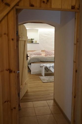 an open door to a bedroom with a bed at Landidyll Am Eisenberg in Kirchberg