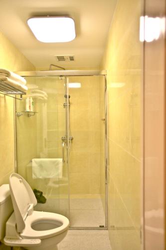 a bathroom with a toilet and a glass shower at The Great Wall Box House - Beijing in Miyun