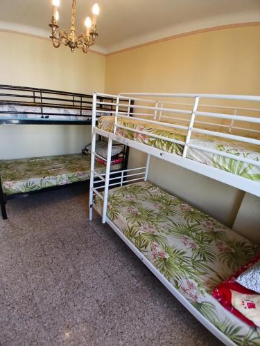 two bunk beds in a room with a chandelier at lits superposé in Marseille