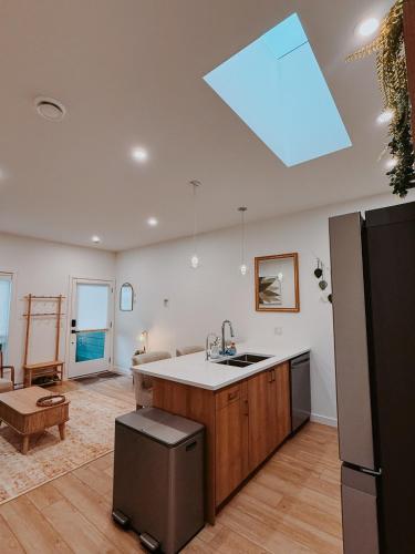 a kitchen with a sink and a counter top at Private Boho Tiny Home - Lakes, Wineries, Hike, Ski in Kelowna