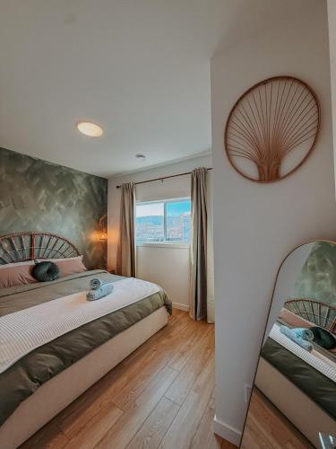 a bedroom with two beds and a window at Private Boho Tiny Home - Lakes, Wineries, Hike, Ski in Kelowna