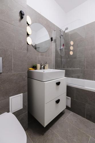 a bathroom with a white sink and a mirror at Cozy Getaway Sector 1 in Bucharest