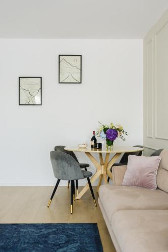 a living room with a table and a couch at Cozy Getaway Sector 1 in Bucharest
