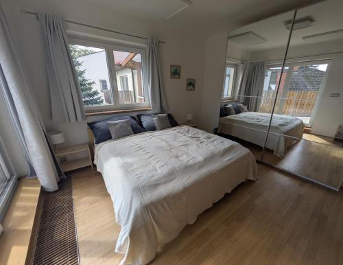 a bedroom with a large bed and a couch at Apartman Amanda in Poděbrady