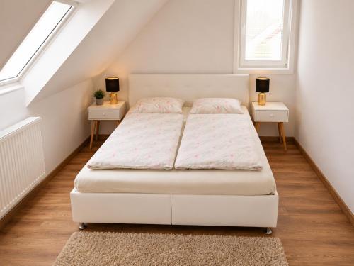 a bedroom with a bed and two night stands at Apartmán Urban Kubín in Dolný Kubín