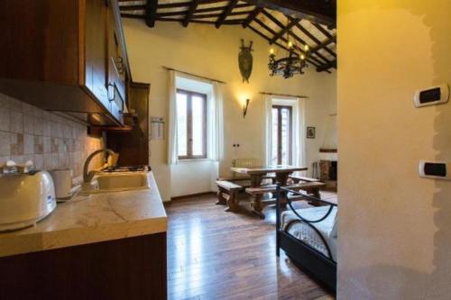 a kitchen with a sink and a table in it at La dimora del ghibellino in Tivoli