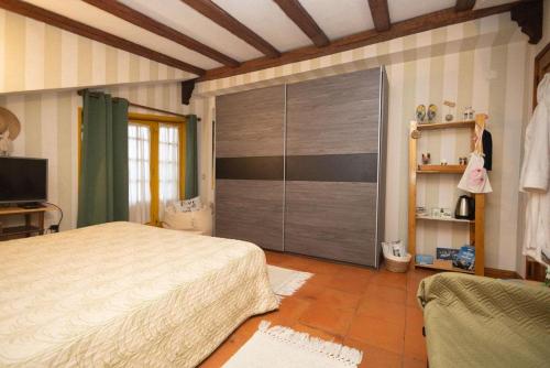 a bedroom with a bed and a large sliding door at Casa Amarela in Esmoriz