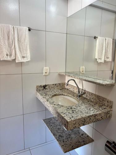a bathroom with a sink and a mirror at Estalagem do Carmo in Pirenópolis