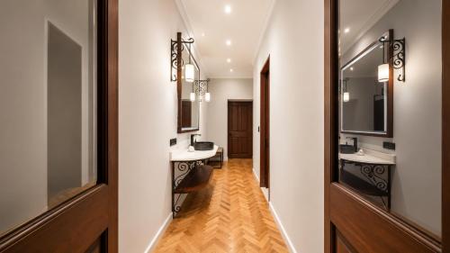 a bathroom with two sinks and two mirrors at Hotel Bellas Artes in Mexico City