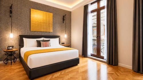a bedroom with a large bed and a window at Hotel Bellas Artes in Mexico City