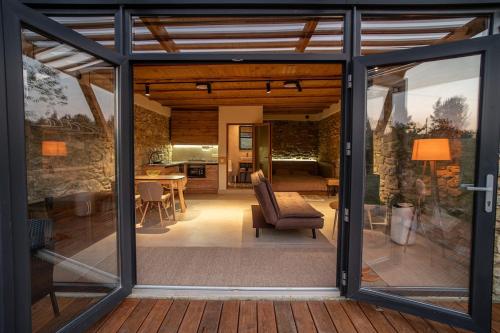 a conservatory with glass doors and a living room at Terra House in Andrushovka