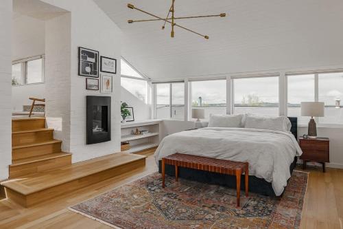 a bedroom with a large bed and a fireplace at Crows Nest Condo 3BR Downtown in Anchorage