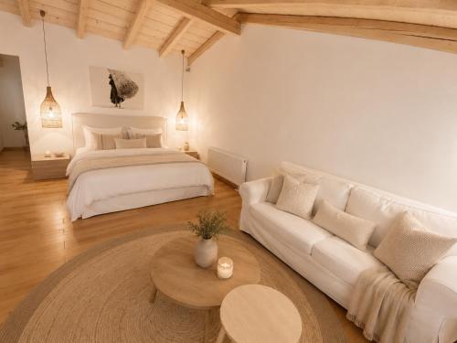 a living room with a bed and a couch at Le Blanc in Dassia