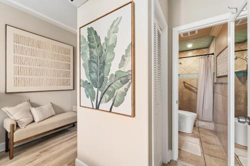 a bathroom with a bench and a painting on the wall at SW Beach Hotel in Hermosa Beach