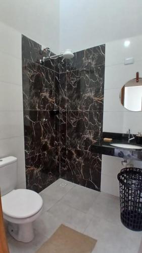 a bathroom with a toilet and a sink at Casa Tranquila com Vaga para carro em Três Lagoas in Três Lagoas