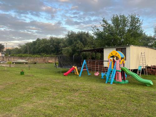 a group of playground equipment in a yard at Camping Two Rivers in Shkodër
