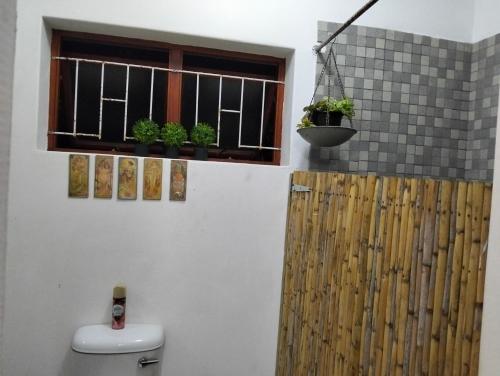 a bathroom with a window with potted plants on it at The Hidden Corner in Sedgefield