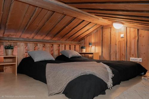 a bedroom with two beds in a attic at Kelo Haven, 2 x skipasses Ruka-Pyhä included, skibus nearby in Ruka