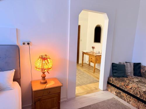 a bedroom with a bed and a lamp on a table at Hotel Dreischläger Hof in Fernthal