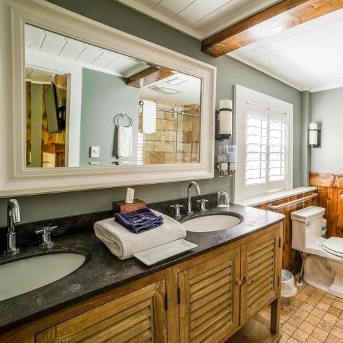a bathroom with two sinks and a large mirror at Hellbender Bed & Beverage in Blowing Rock