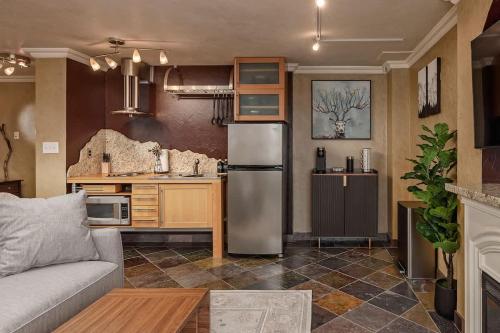 a kitchen with a stainless steel refrigerator in a room at Downtown Condo Epic Views in Anchorage